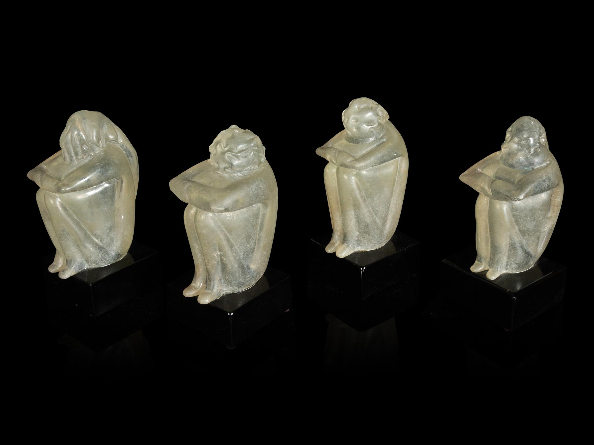 A Group of Four Glass Figural Groups