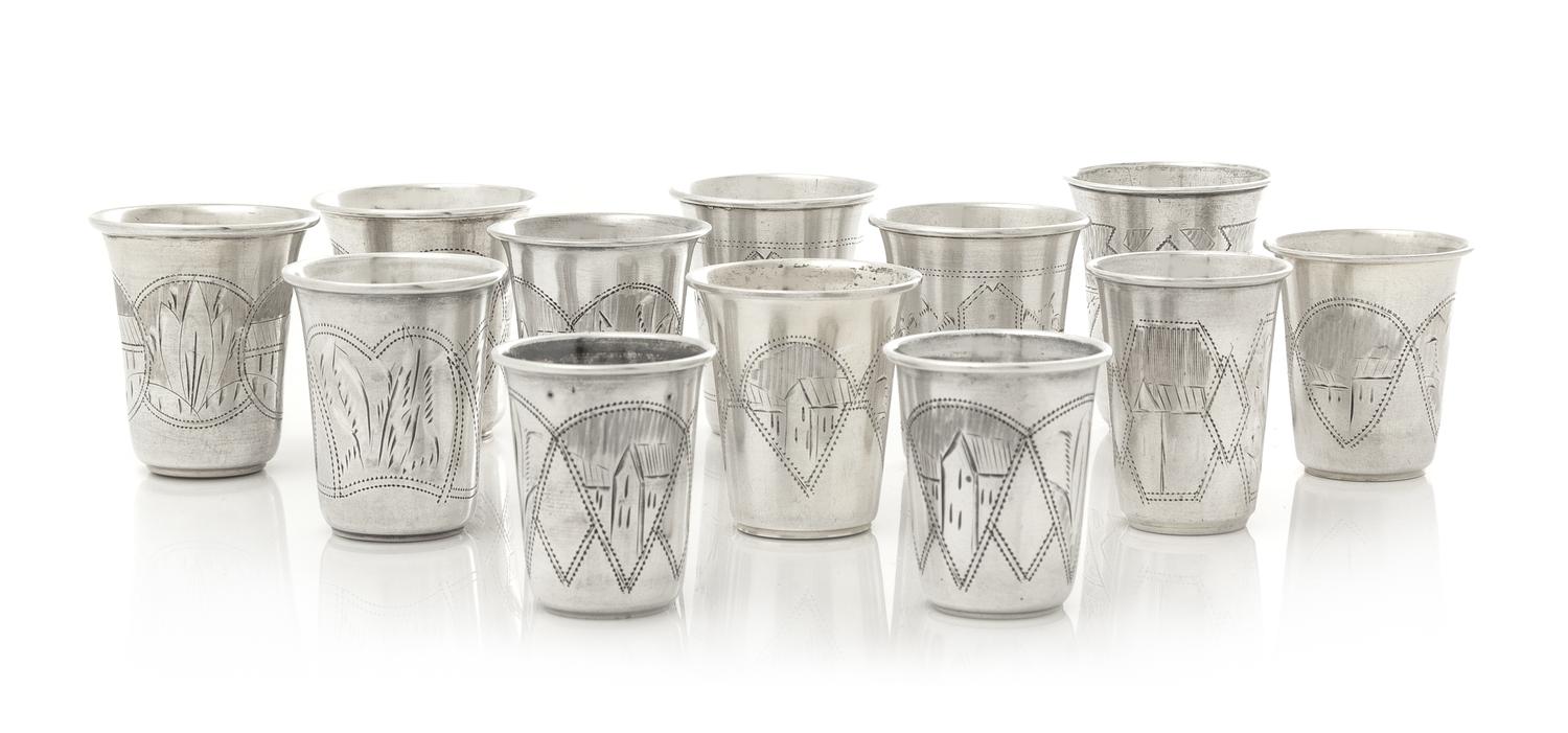 A Group of Eleven Russian Silver Beakers, Various Makers, Late 19th/Early 20th Century, each having a flared rim, the bodies worked to