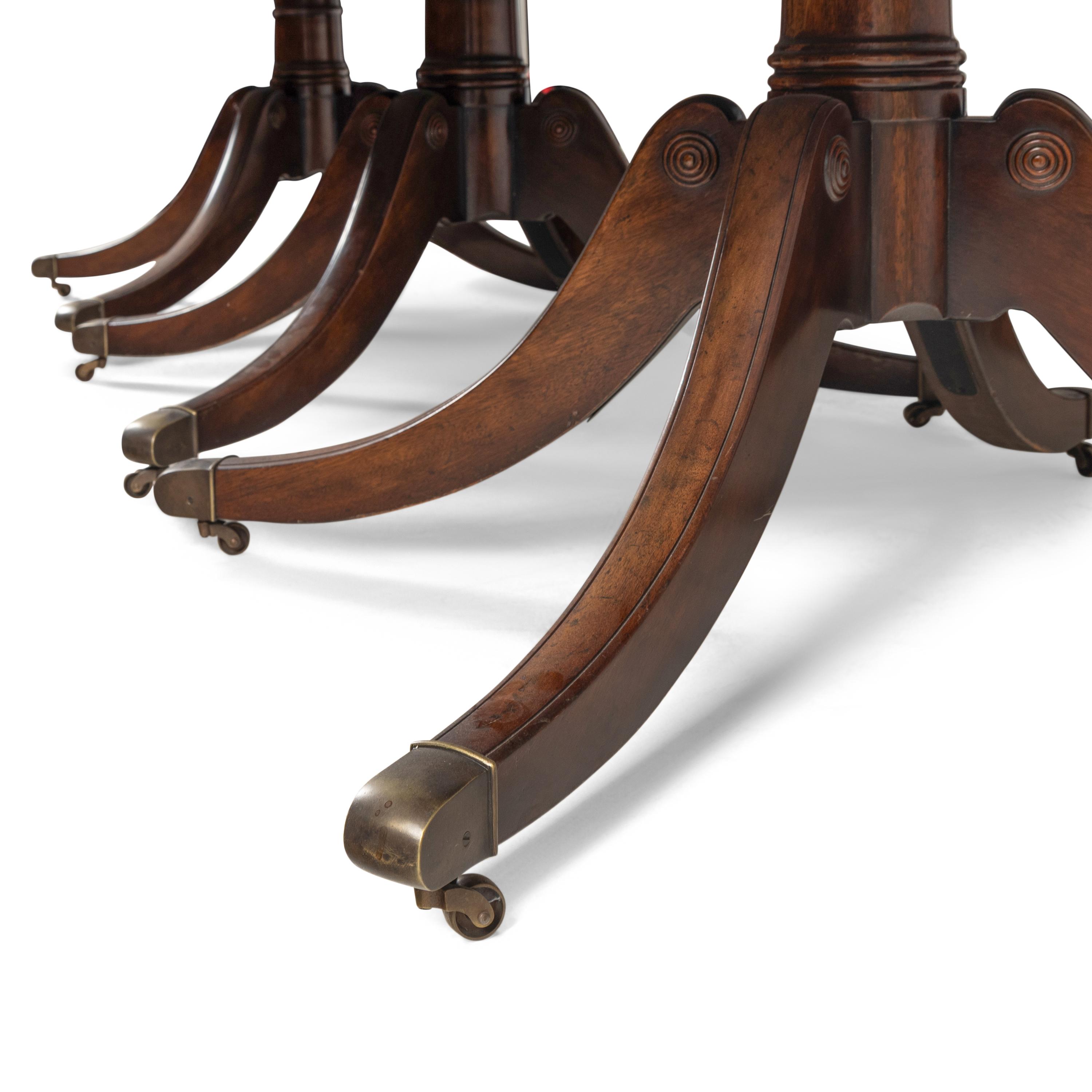 A Regency Style Mahogany and Satinwood Three-Pedestal Dining Table