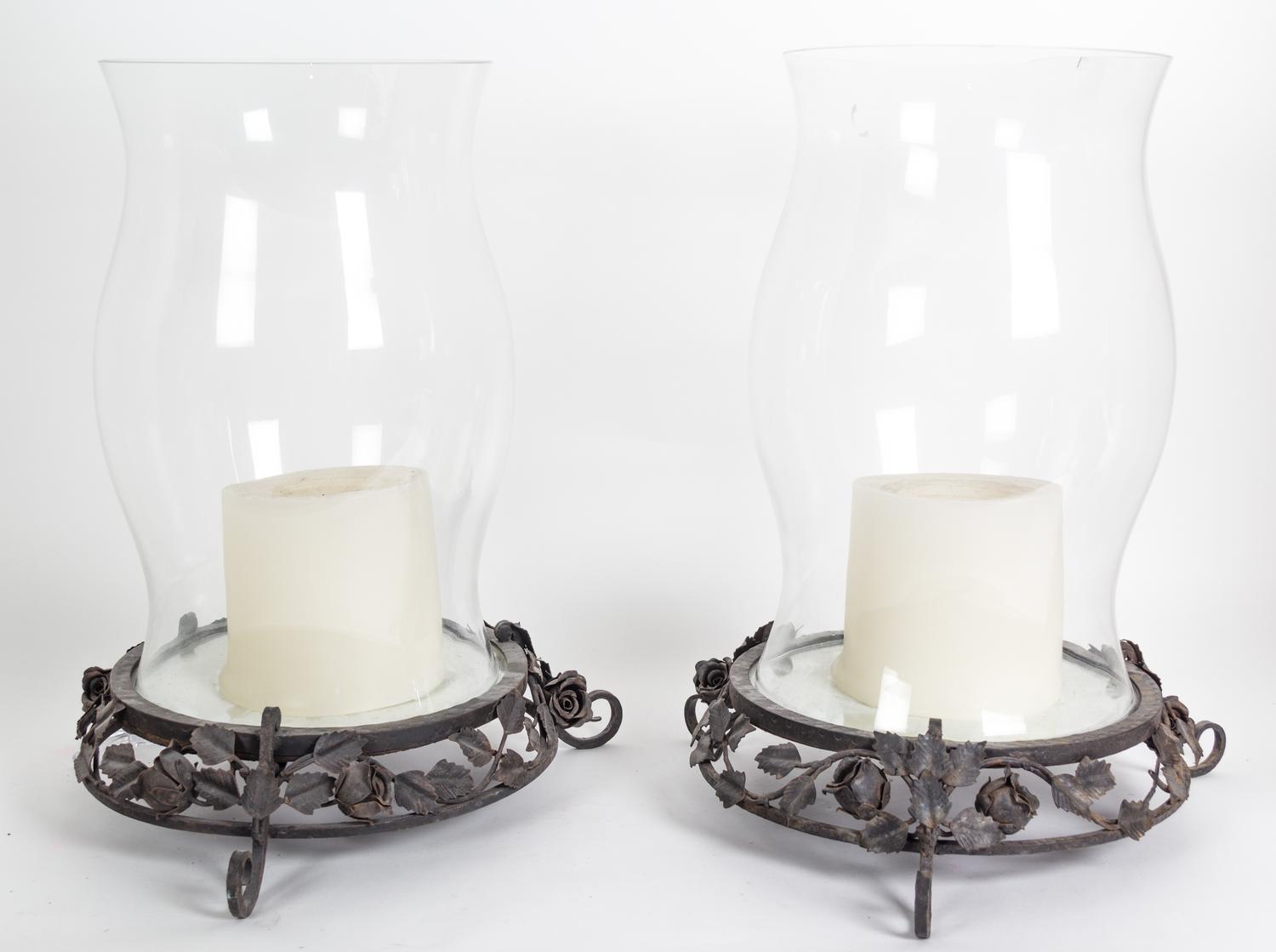 A Pair of Glass Hurricane Shades on Metal Bases Overall height 21 1/2 inches.