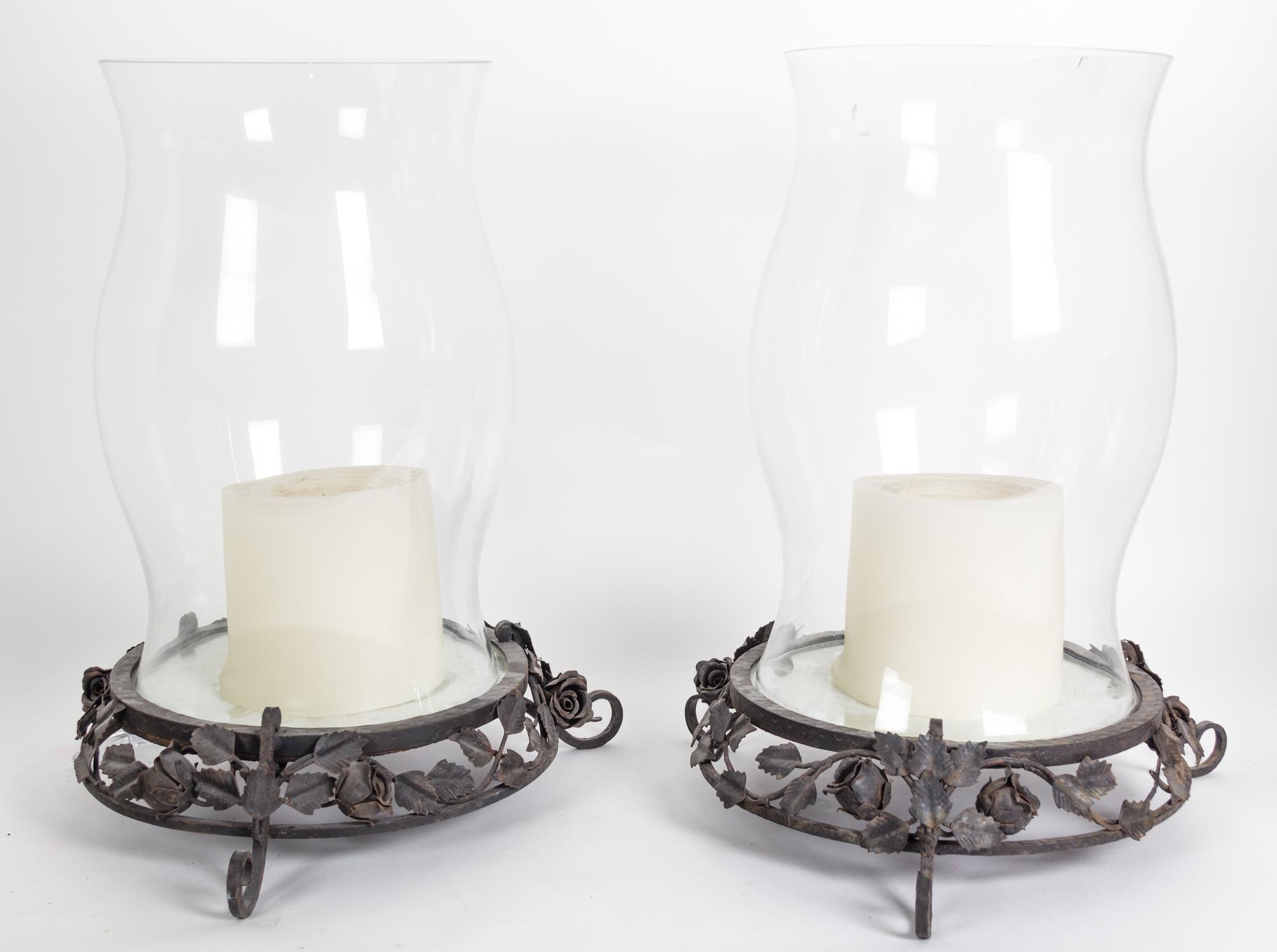 A Pair of Glass Hurricane Shades on Metal Bases Overall height 21 1/2 inches.