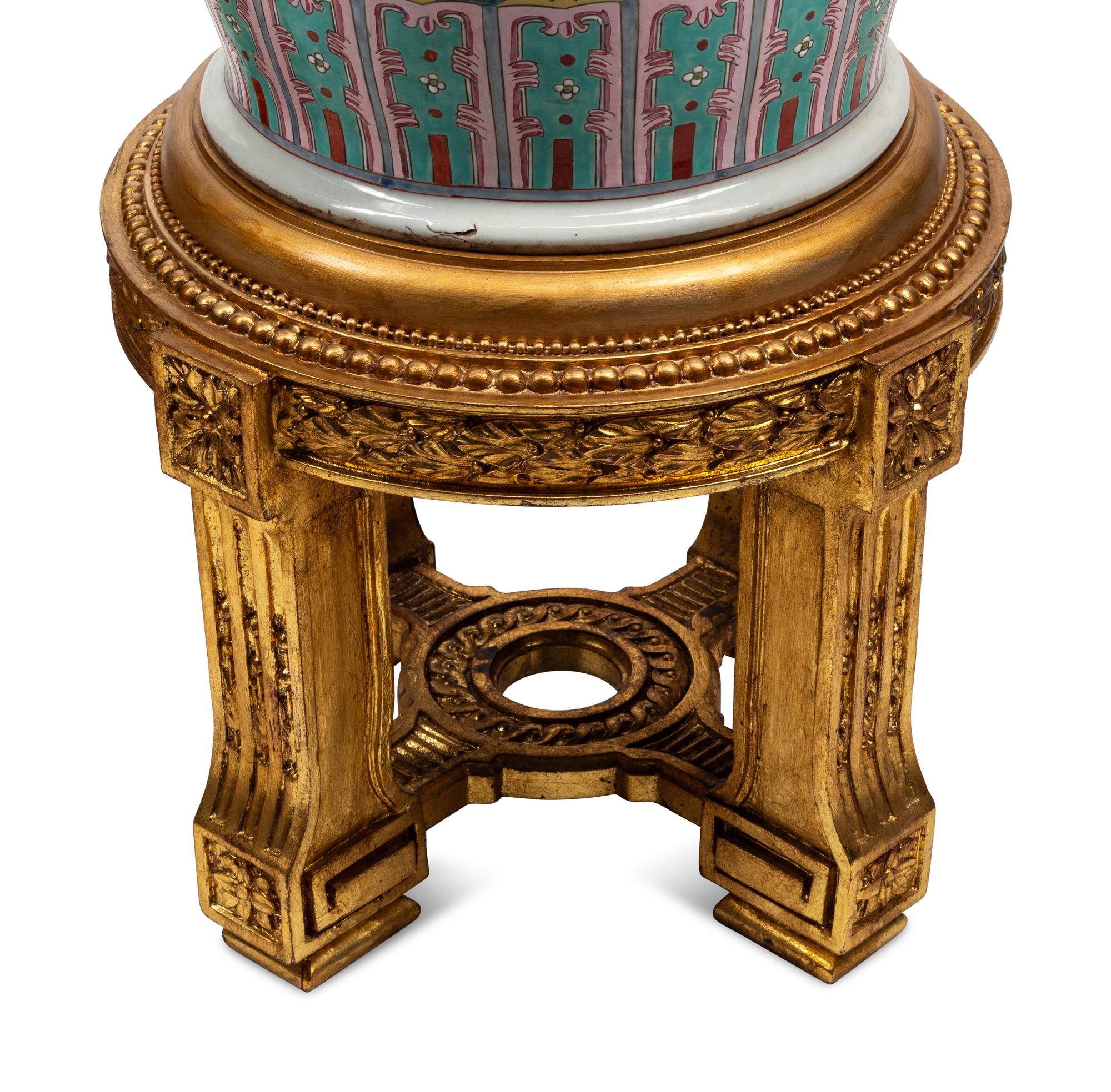 A Pair of Monumental Famille Jaune Porcelain Vases on Giltwood Stands