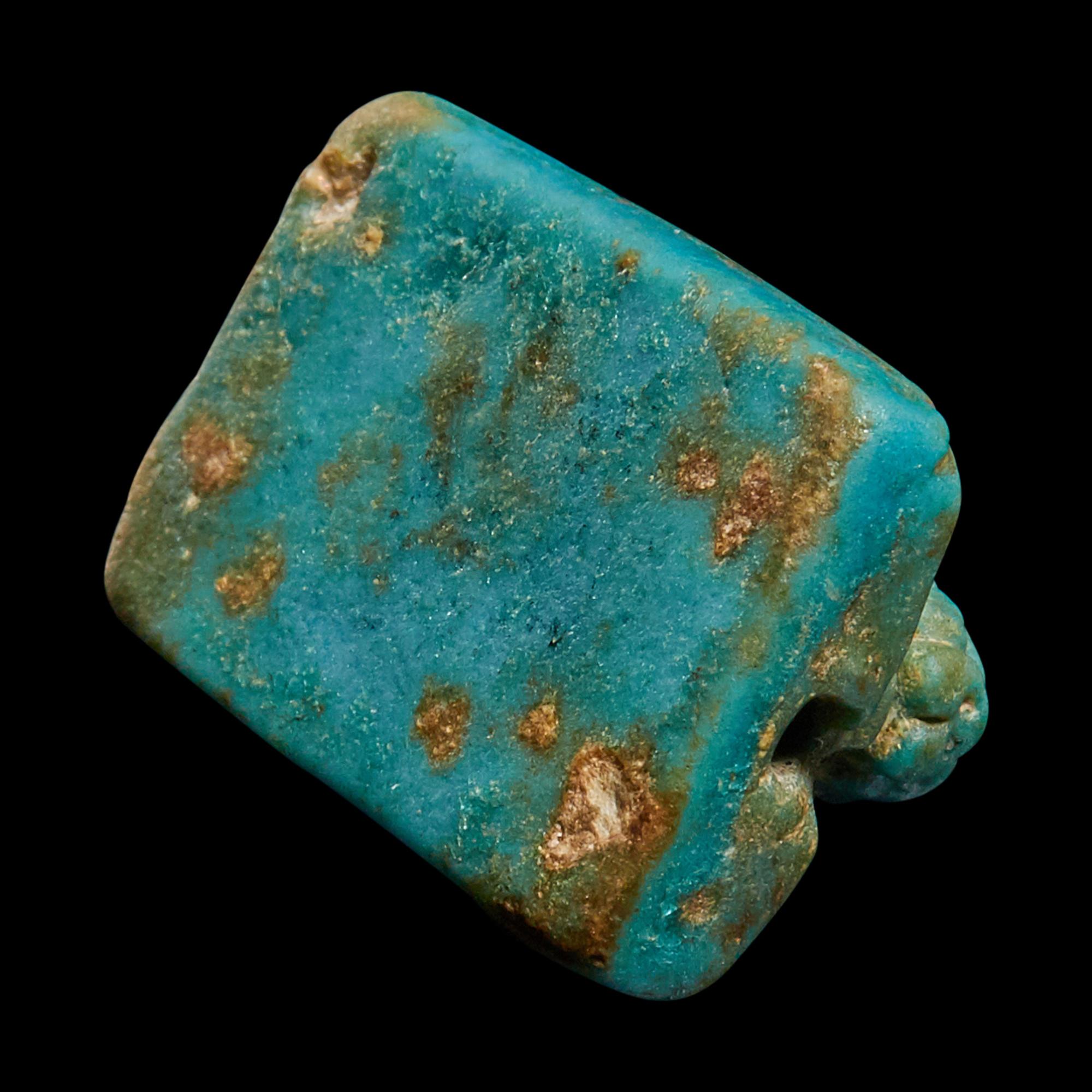 An Egyptian Faience Recumbent Lion Bead