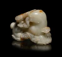 A Chinese Russet and White Jade Carving of a Mythical Beast