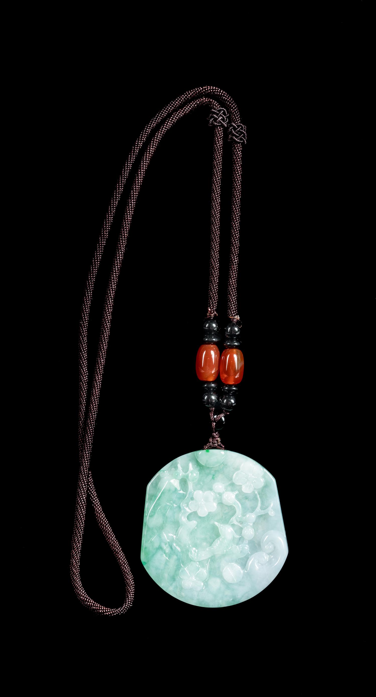 A Celadon and White Jadeite Pendant Length 2 inches. — 20TH CENTURY