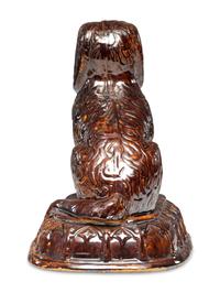A Rare Rockingham Glazed Molded Yelloware Forward-Facing Dog
