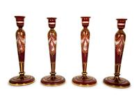 A Set of Four Bohemian Ruby Cut-to-Clear Glass Candlesticks with Gilt Decoration. — 19th Century