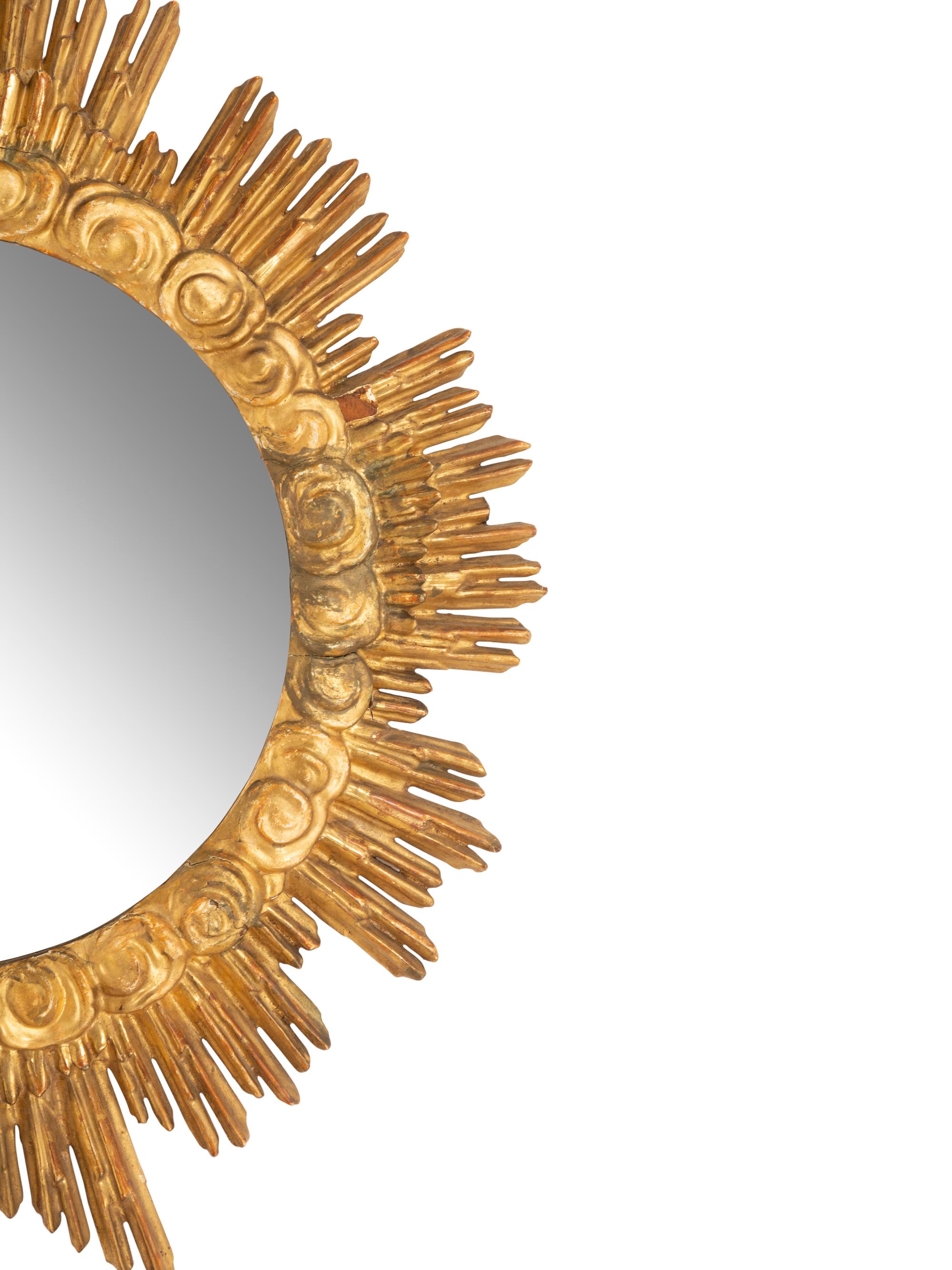 An Italian Carved Giltwood Sunburst and Cloud Framed Mirror