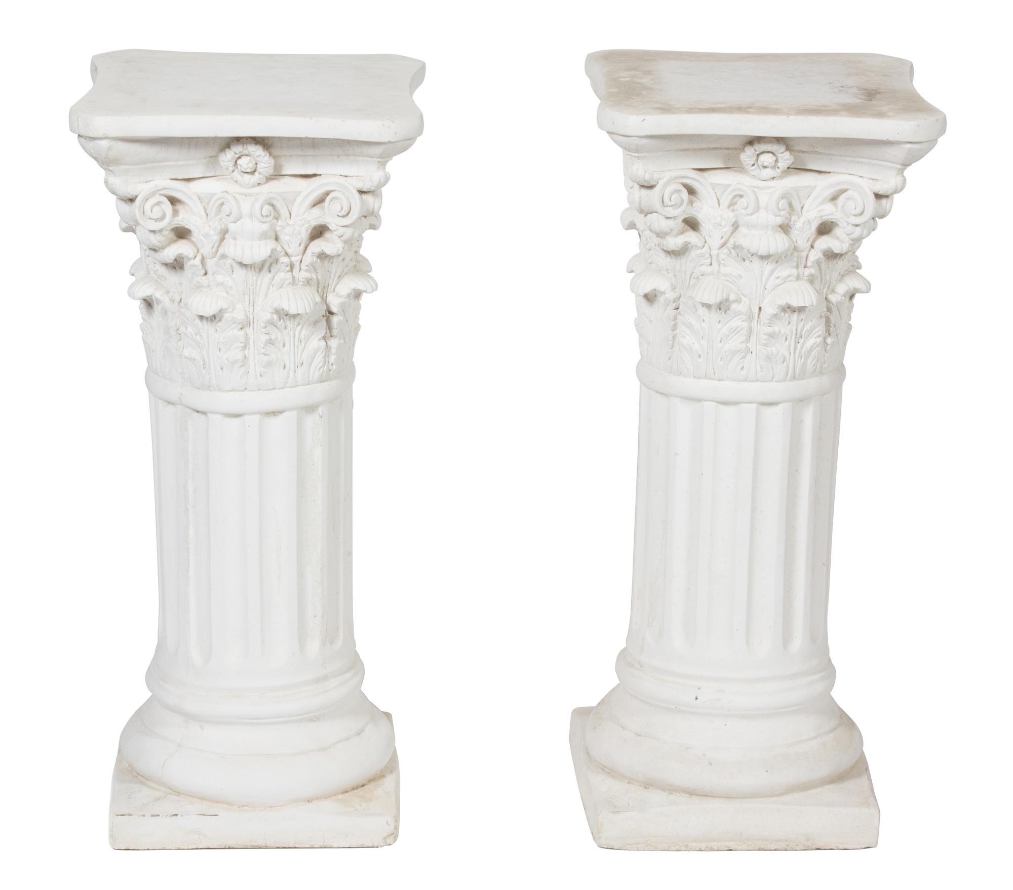 A Pair of Cast Stone Corinthian Capital Column Form Pedestals Height 29 x width 13 x depth 13 inches.