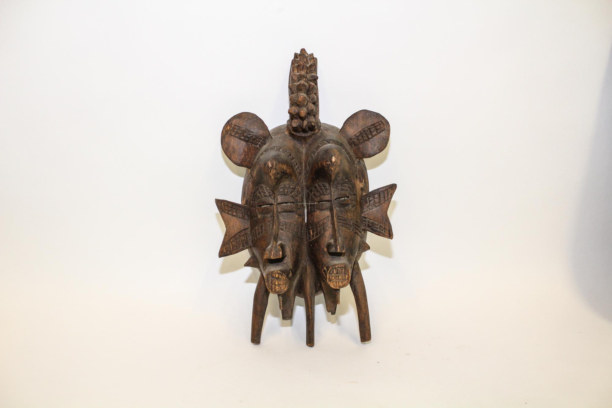 A Carved African Double Mask Height 13 1/2 inches. — MID TO LATE 20TH CENTURY