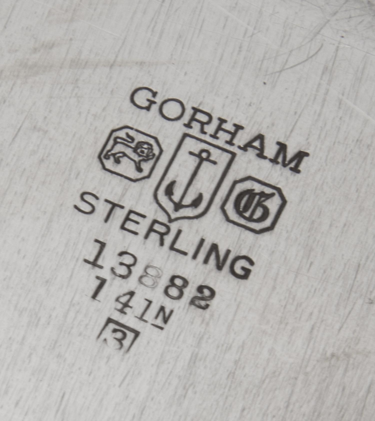 An American Silver Meat Platter, Gorham Mfg. Co., Providence, RI, 1943, of shaped circular form having a gadrooned border, the center e