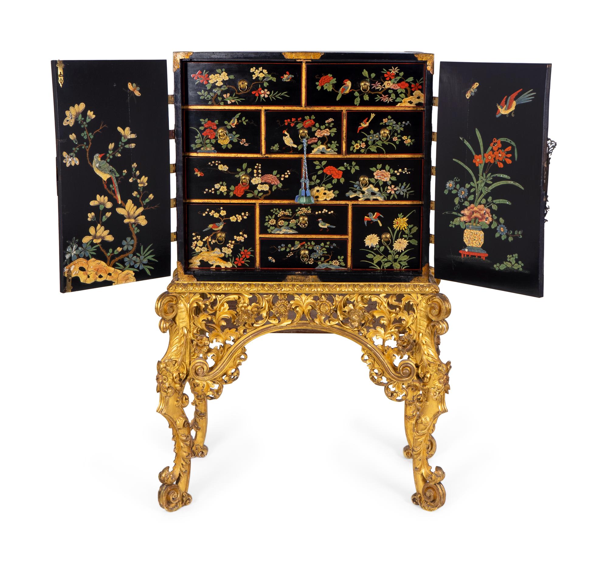 A Chinese Brass-Mounted Gilt-Decorated Black Lacquer Cabinet on Later Giltwood Stand — 18TH/19TH CENTURY