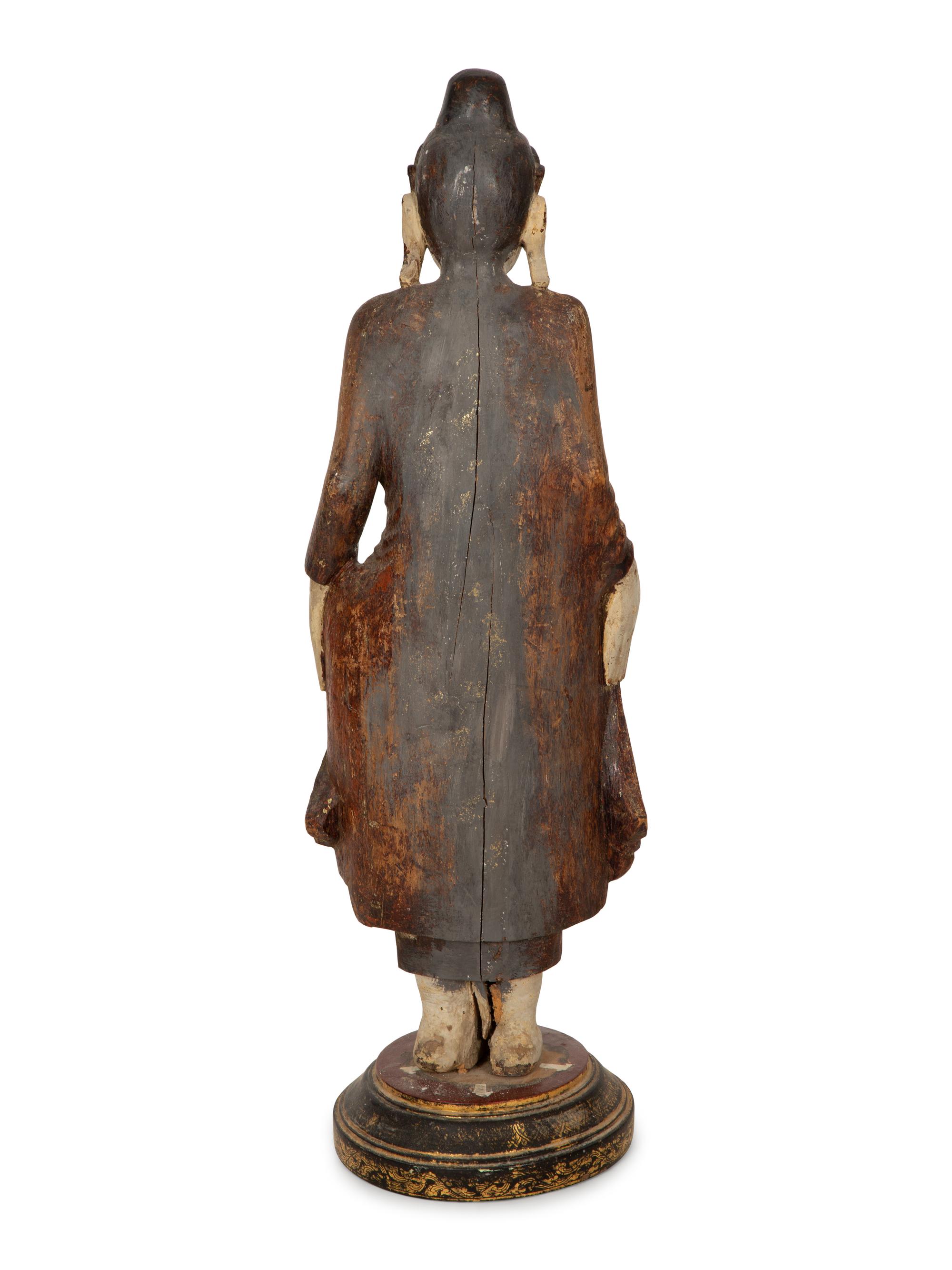 An Indonesian Carved and Painted Figure of a Buddhist Monk