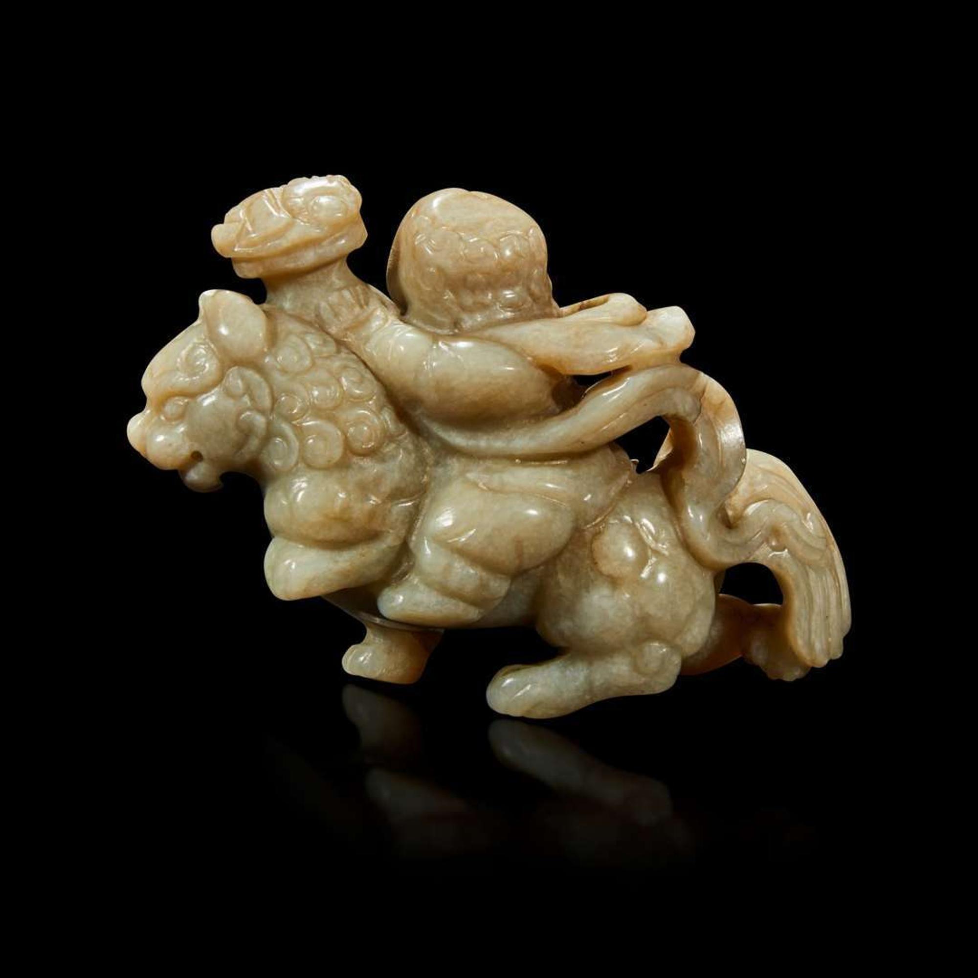 A Chinese greyish white jade carving of a foreigner on a mythical beast 18th Century or earlier