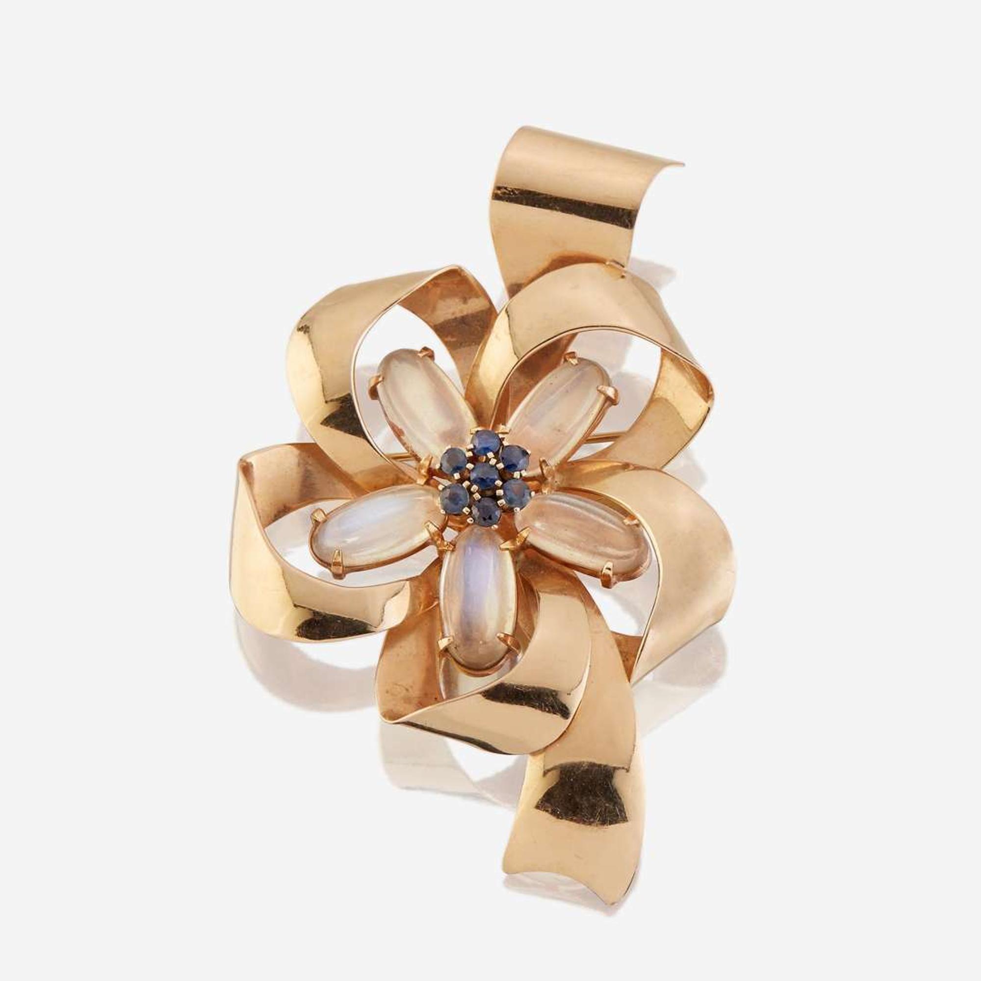 A fourteen karat gold, moonstone, and sapphire brooch