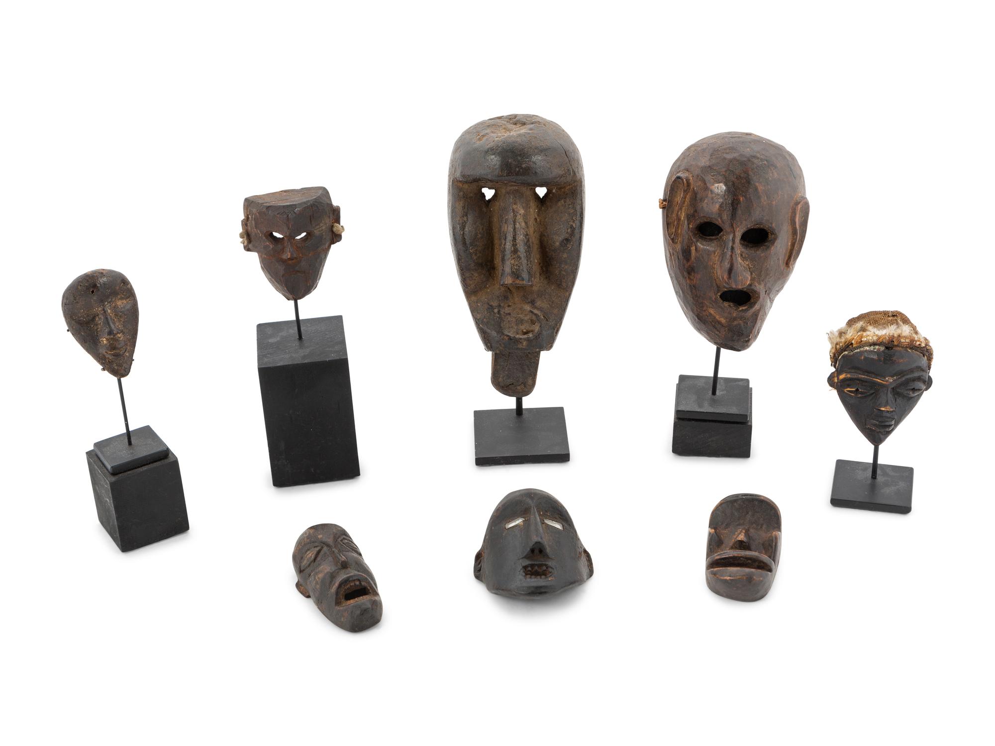 A Group of Eight Miniature Ethnographic Carved Masks