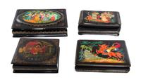 A Collection of Four Russian Lacquered Boxes, 20th Century, each of rectangular form with hinged lid, decorated with folk scenes.