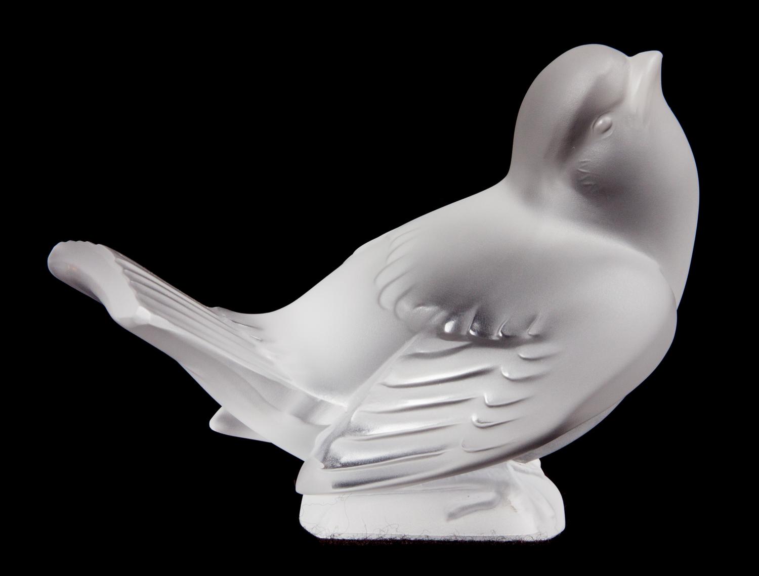 A Lalique Molded and Frosted Glass Bird Figurine Height 3 1/8 inches.