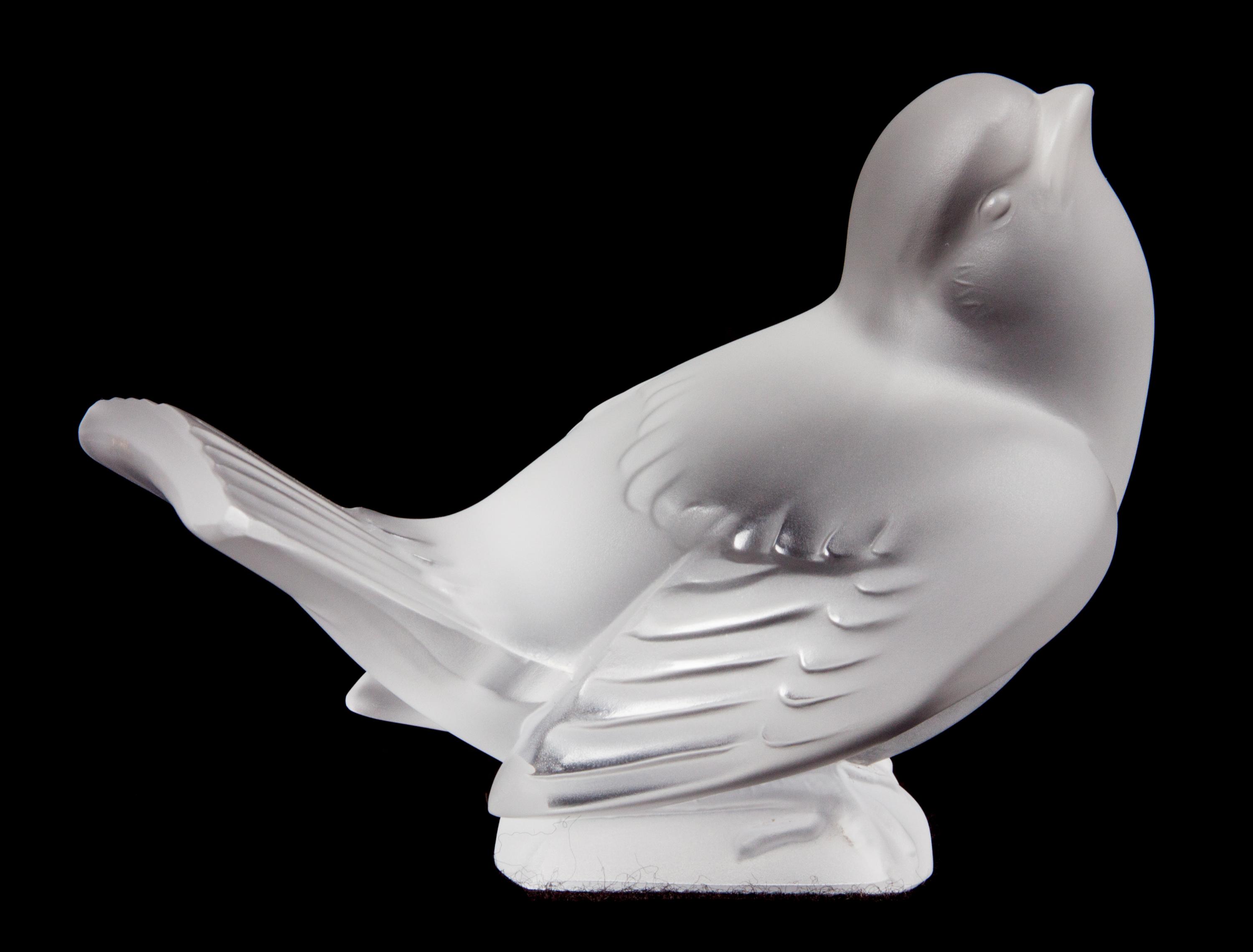 A Lalique Molded and Frosted Glass Bird Figurine Height 3 1/8 inches.