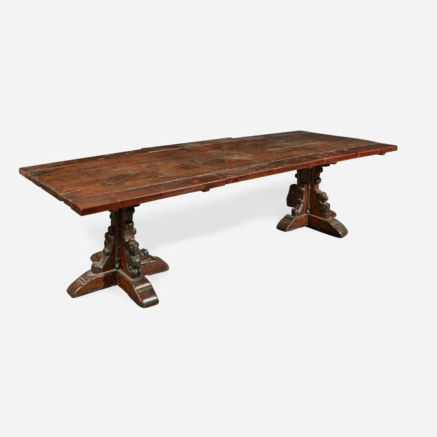 A Gothic Revival carved oak dining table composed of elements likely dating to the 17th century and later
