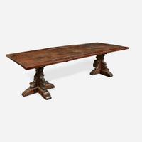 A Gothic Revival carved oak dining table composed of elements likely dating to the 17th century and later