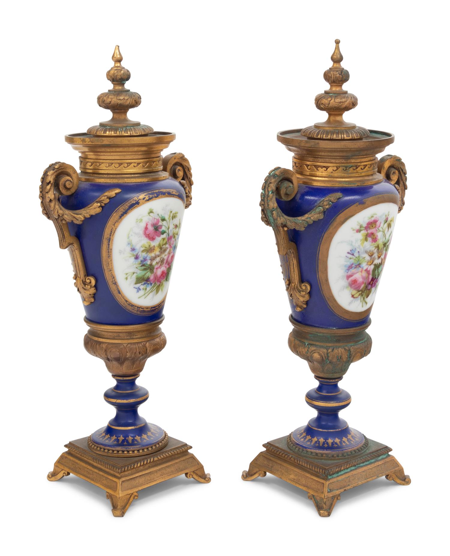 A Pair of Sèvres Style Gilt Bronze Mounted Porcelain Urns