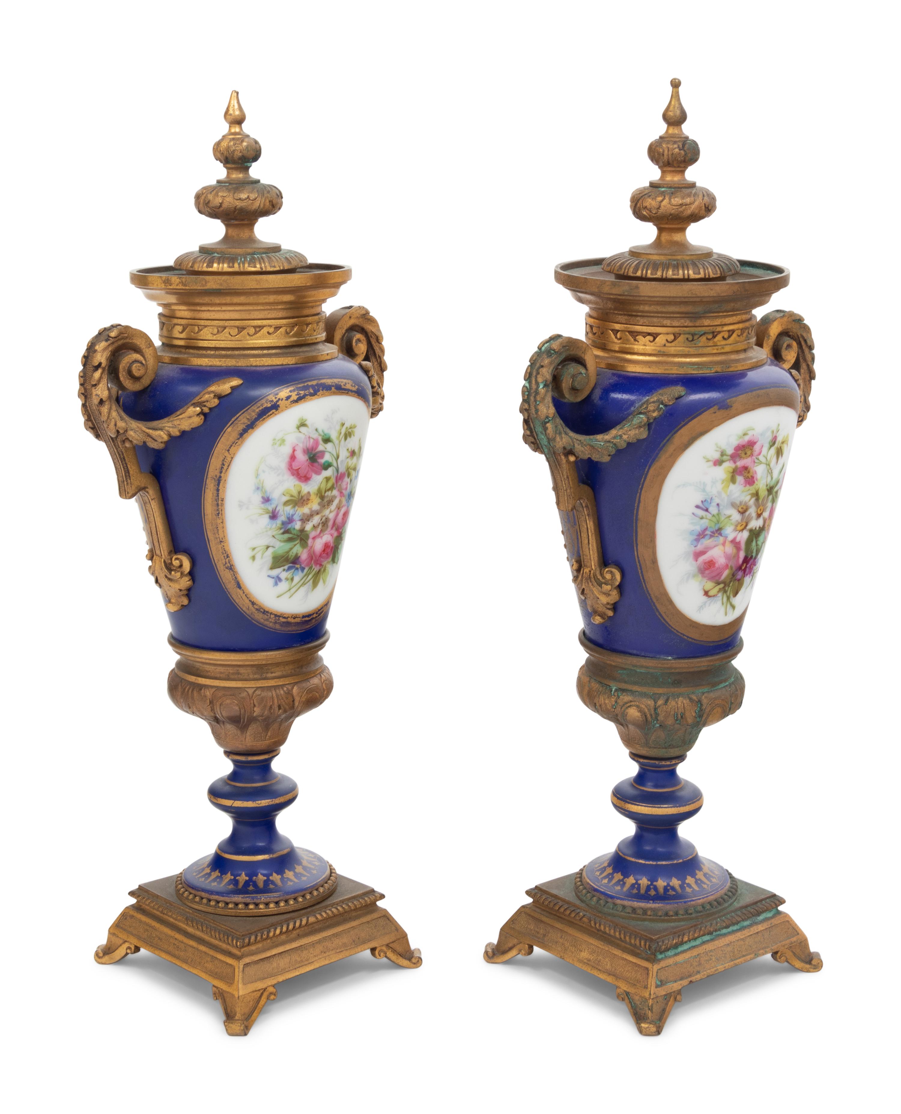 A Pair of Sèvres Style Gilt Bronze Mounted Porcelain Urns