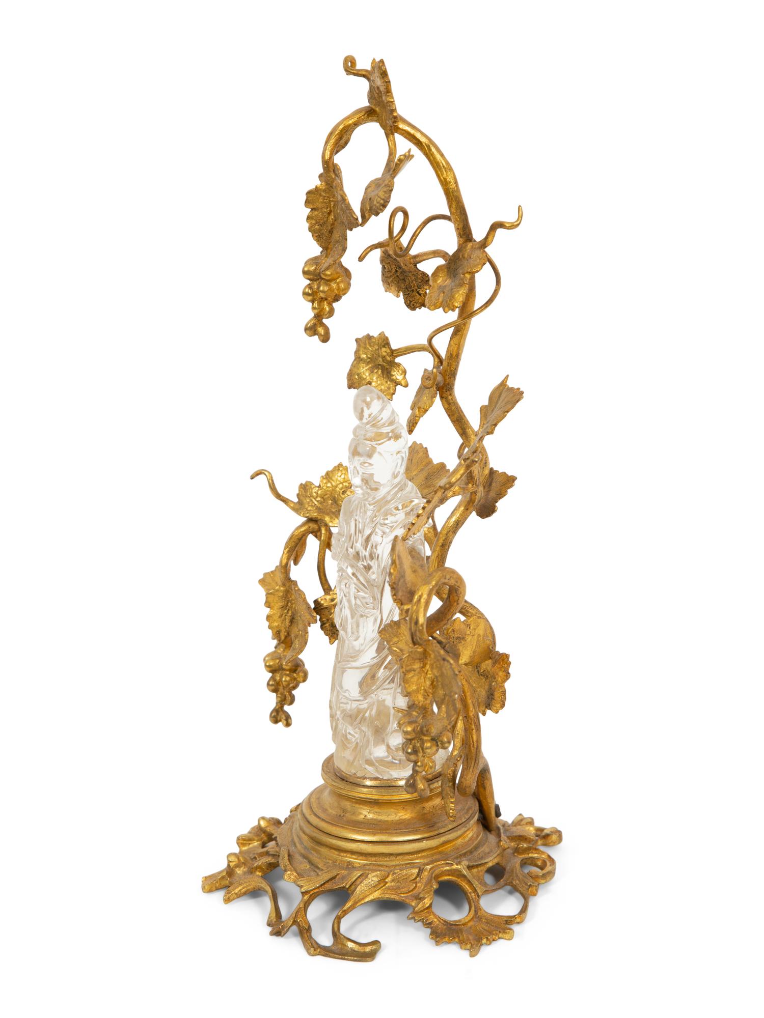 A Carved Rock Crystal Figure of Guanyin on a Grapevine Decorated Gilt Bronze Stand