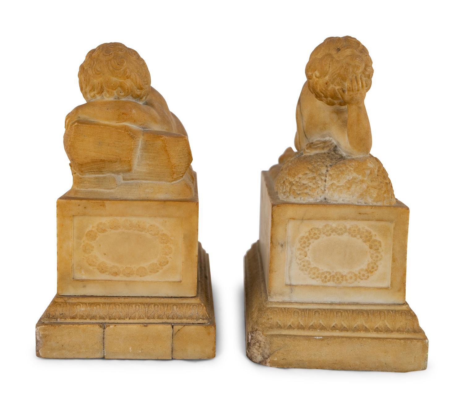 A Pair of Marble Models of Sleeping Cherubs on Plinths