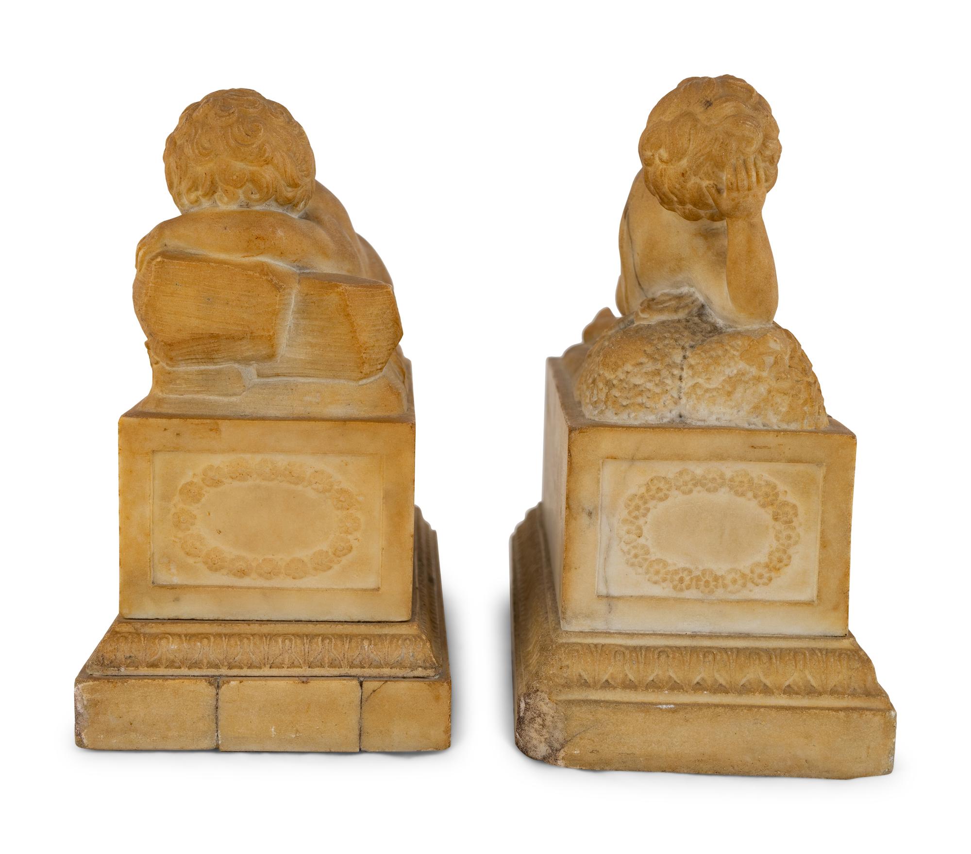 A Pair of Marble Models of Sleeping Cherubs on Plinths
