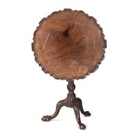 A Chippendale Carved and Figured Mahogany Pie-Crust Tilt-Top Tea Table