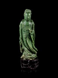 A Mottled Green Jade Figure of Guanyin