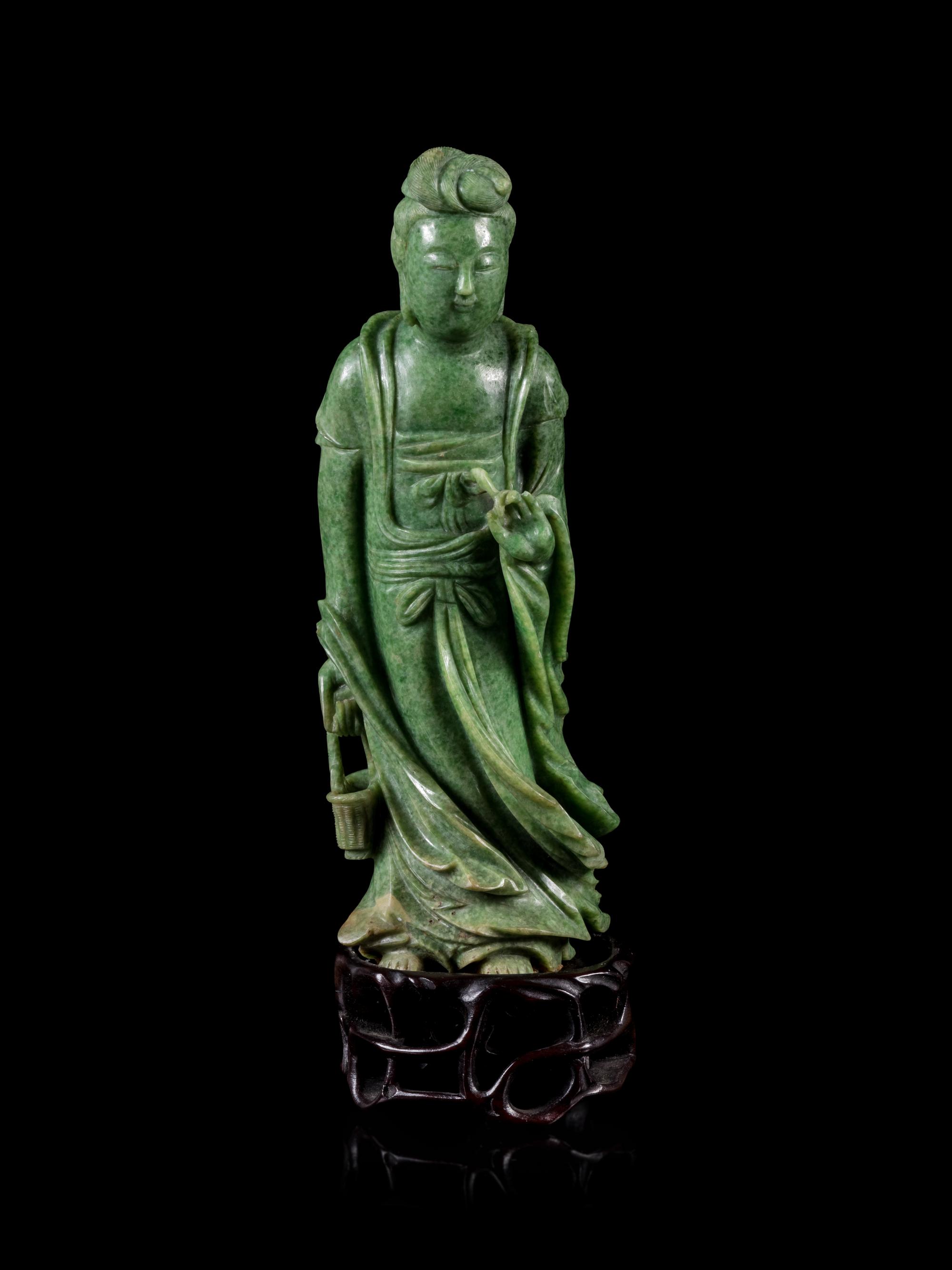 A Mottled Green Jade Figure of Guanyin