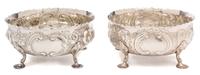 A Pair of Victorian Silver Bowls, Daniel & Charles Houle, London, 1880, each chased with flower heads and C-scrolls and raised on three