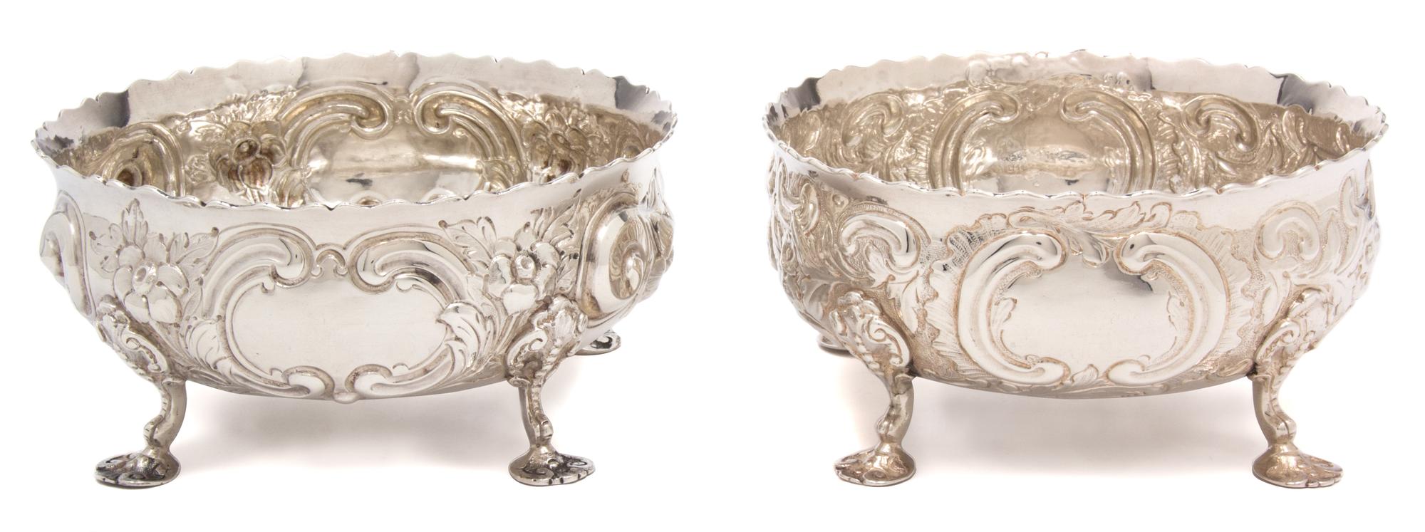 A Pair of Victorian Silver Bowls, Daniel & Charles Houle, London, 1880, each chased with flower heads and C-scrolls and raised on three