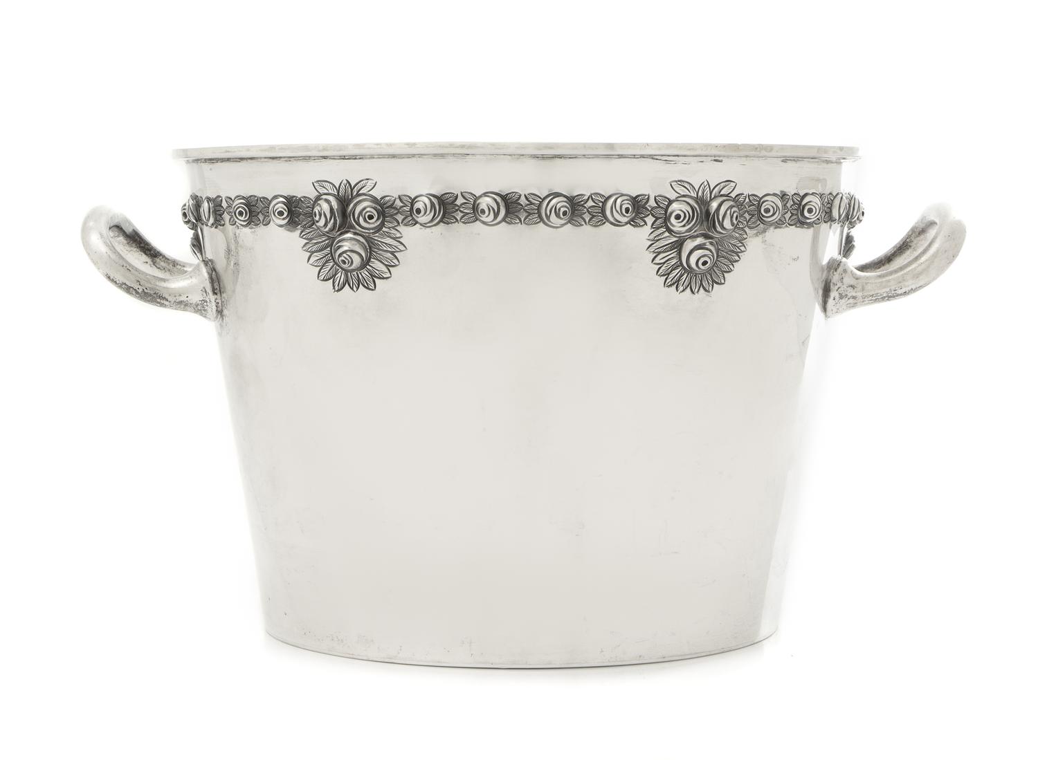A Mexican Silver Ice Bucket, Sanborns, Mexico City, 20th Century, the tapering body with twin handles and a repousee band of rosettes.