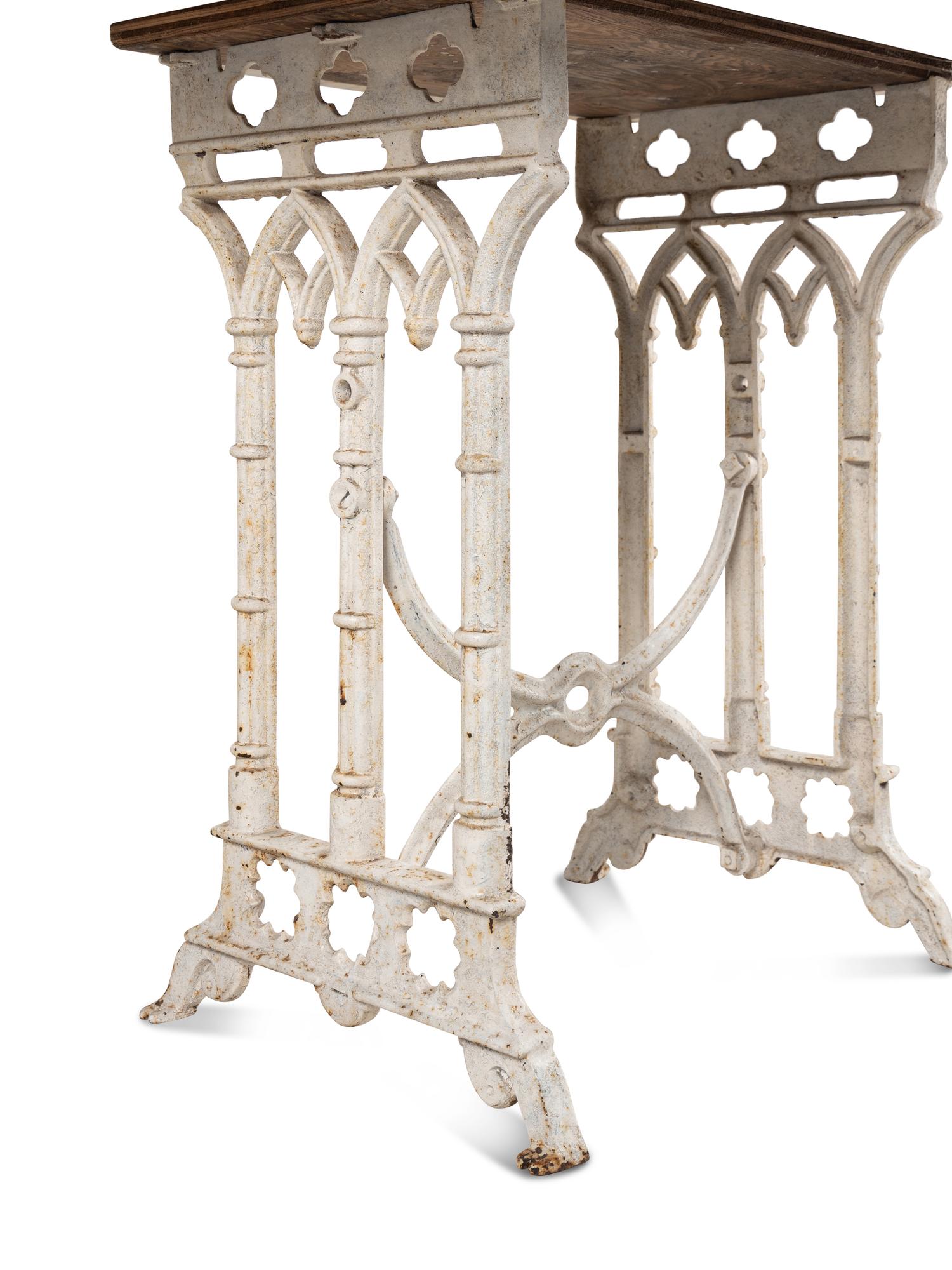 A Continental Gothic Style Painted Cast Iron Marble-Top Garden Table