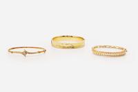 A Collection of Yellow Gold Bangles