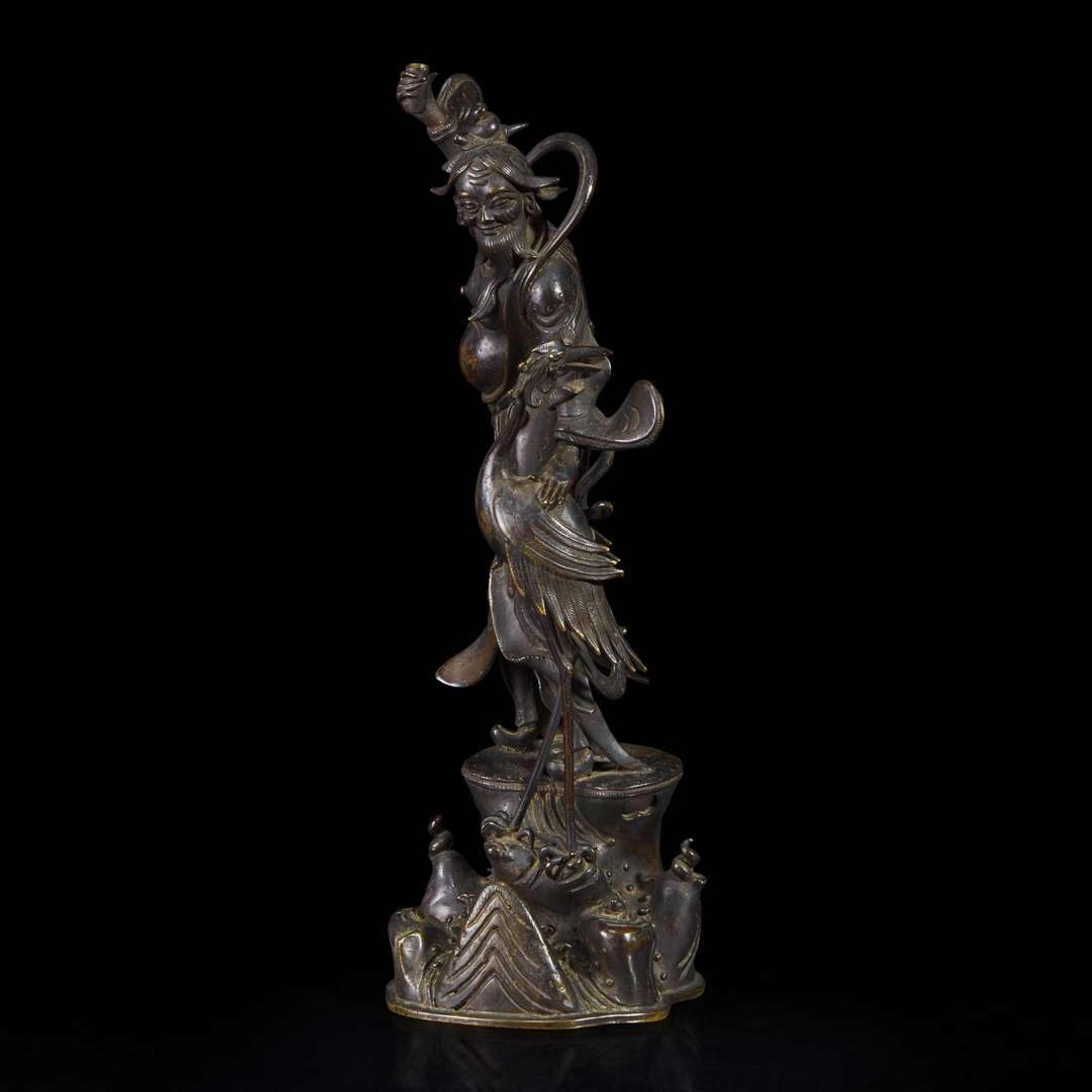 A patinated bronze figure of a Daoist immortal with crane 道教仙人与鹤铜塑 17th century ????