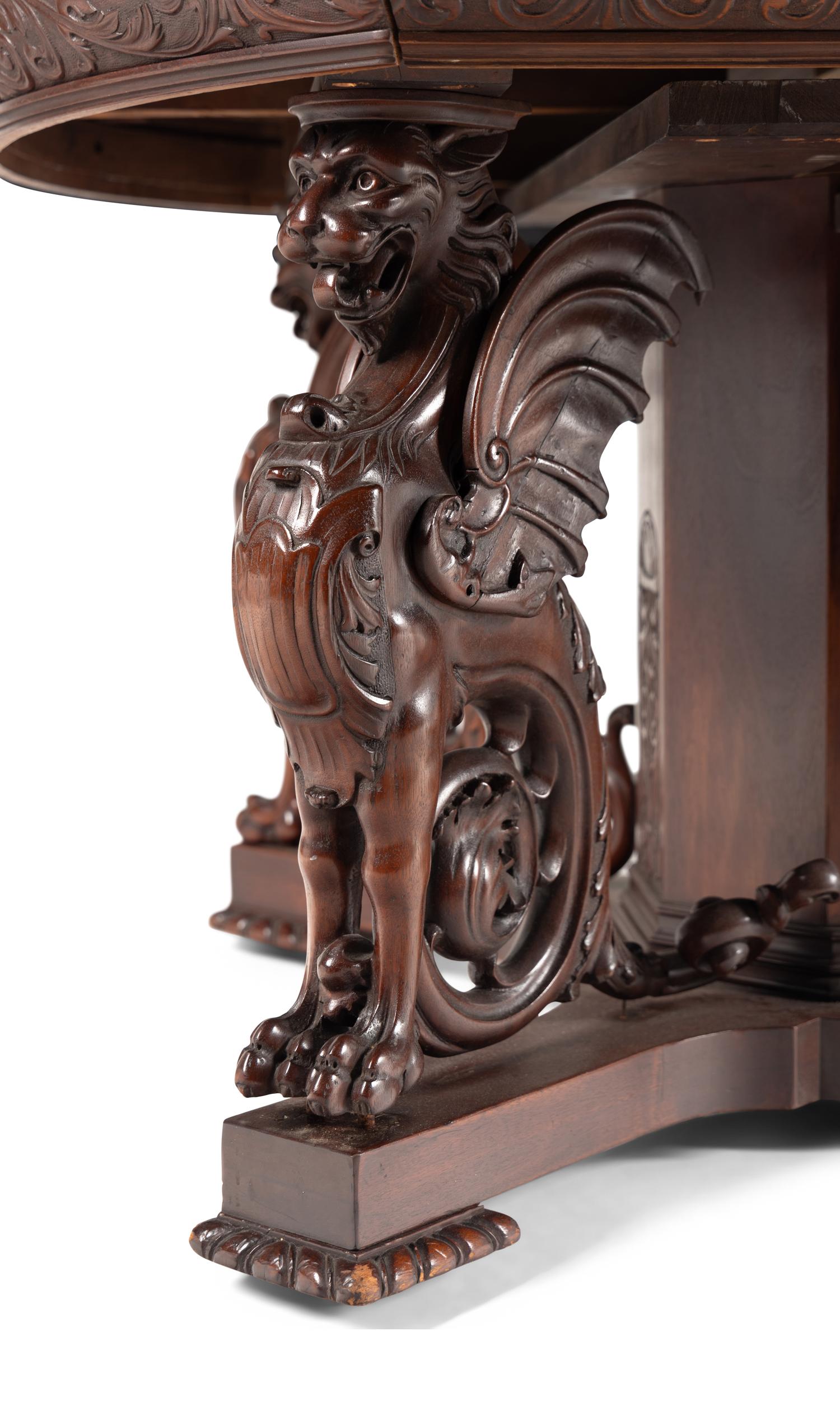 A Renaissance Revival Carved Mahogany Dining Table and Set of Six Chairs