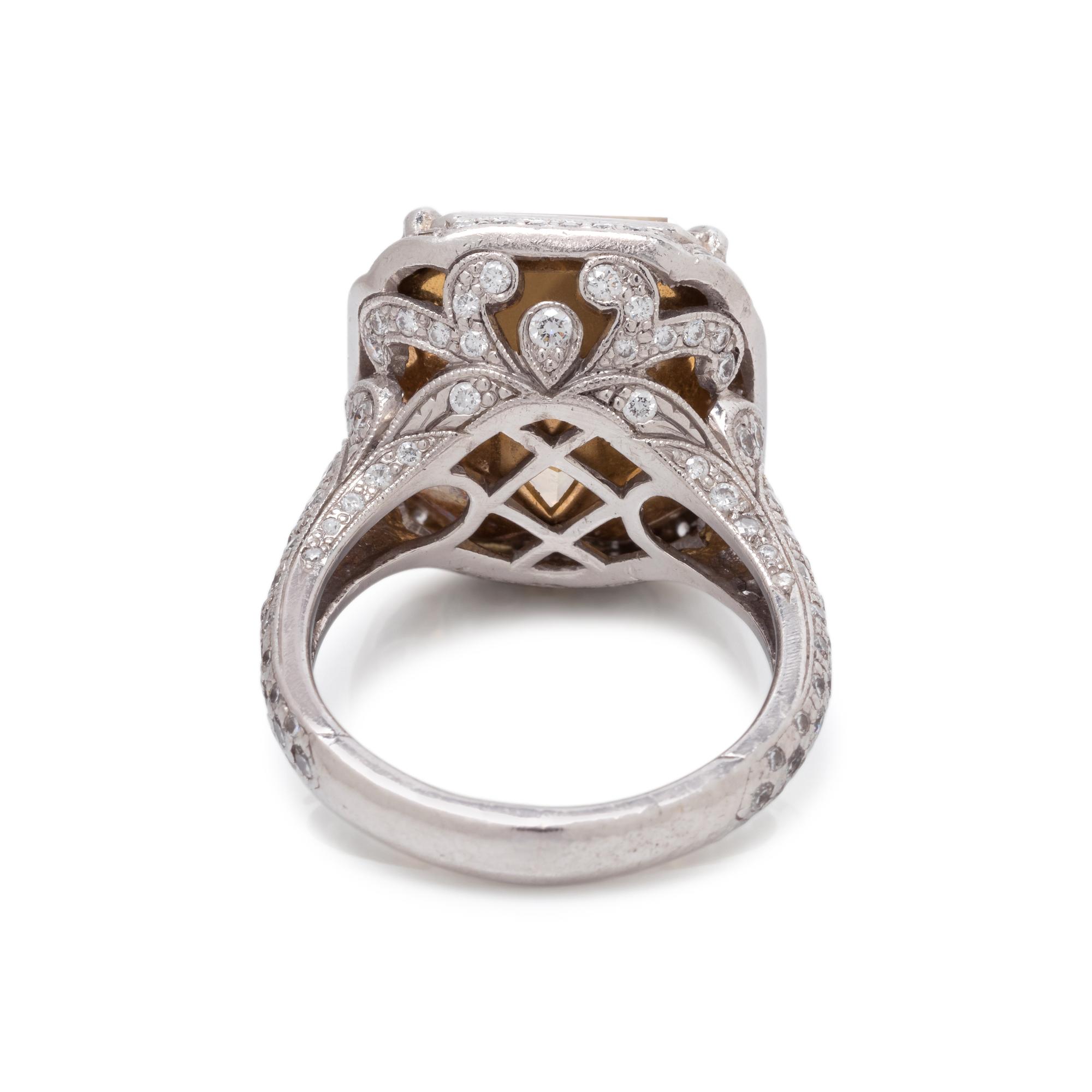 AN IMPRESSIVE FANCY YELLOW DIAMOND AND DIAMOND RING