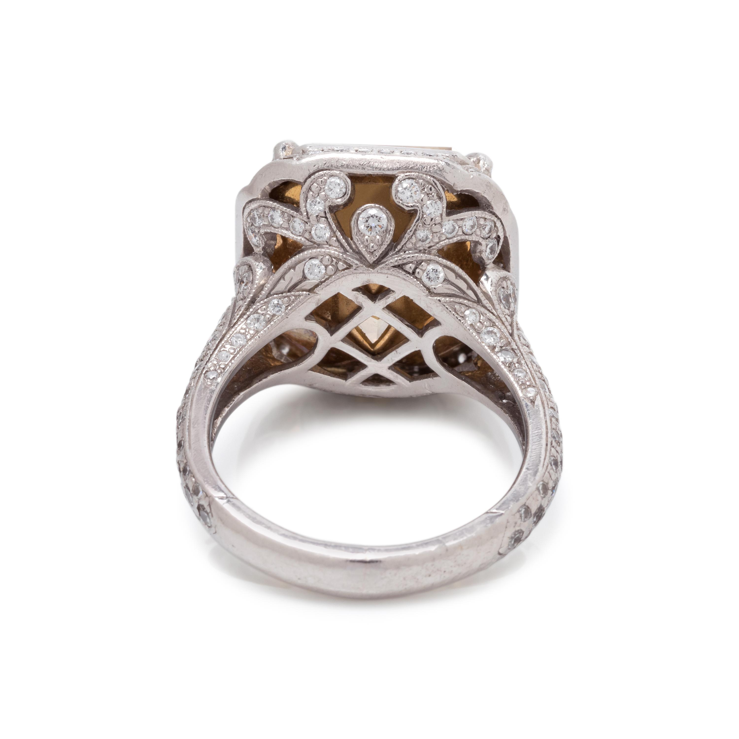AN IMPRESSIVE FANCY YELLOW DIAMOND AND DIAMOND RING