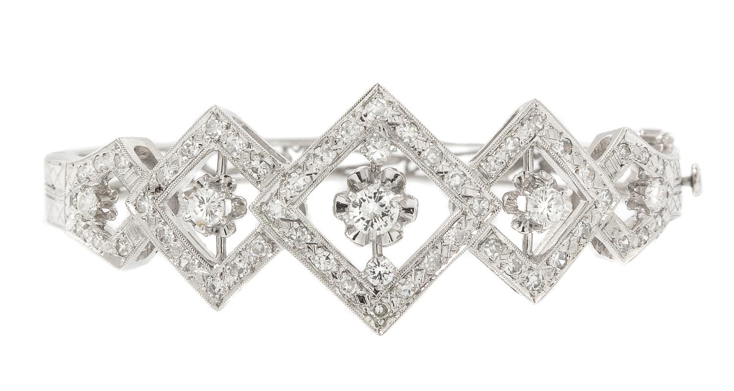 A 14 Karat White Gold and Diamond Hinged Bangle Bracelet, 13.90 dwts.