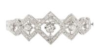A 14 Karat White Gold and Diamond Hinged Bangle Bracelet, 13.90 dwts.