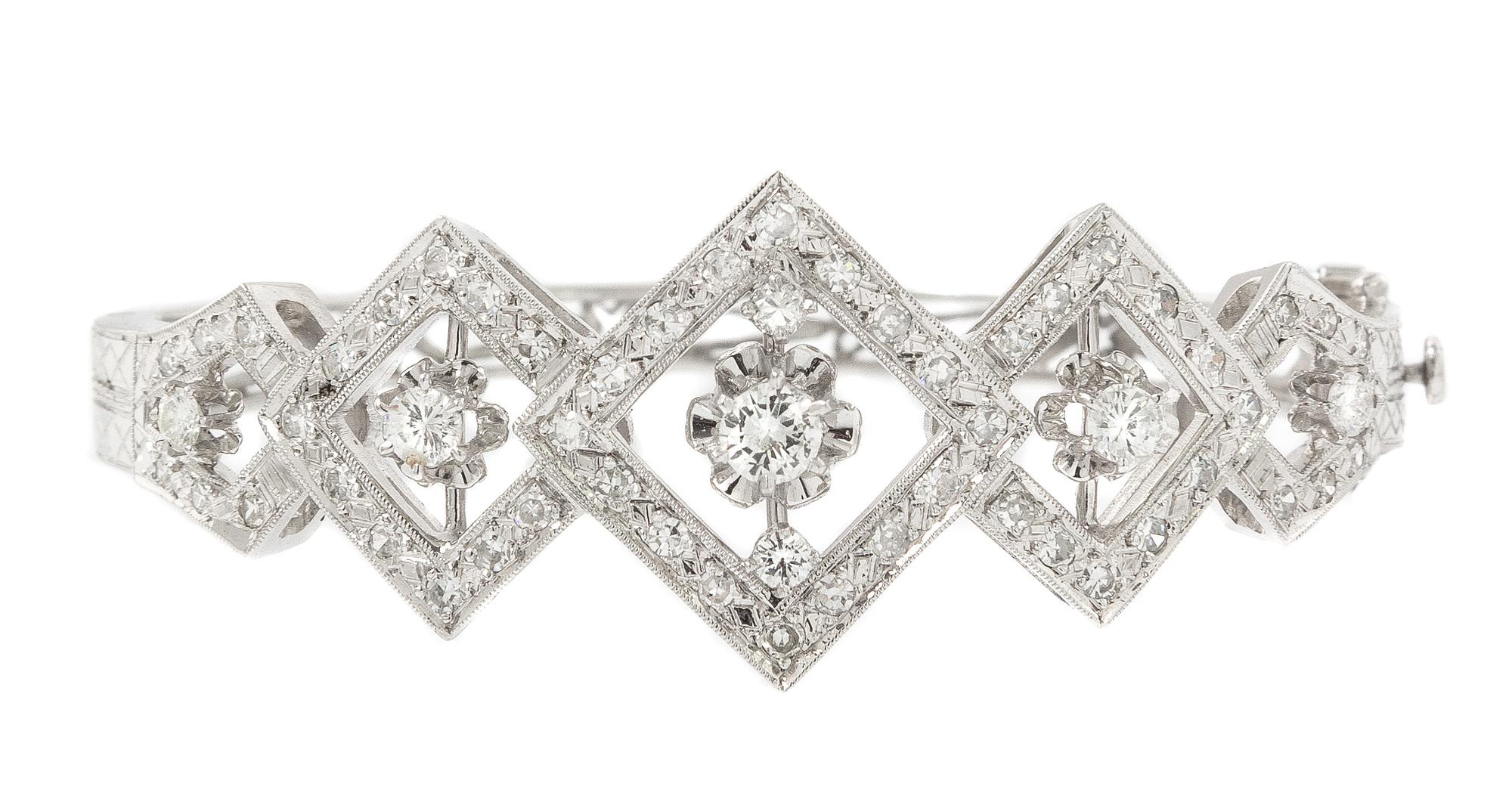 A 14 Karat White Gold and Diamond Hinged Bangle Bracelet, 13.90 dwts.
