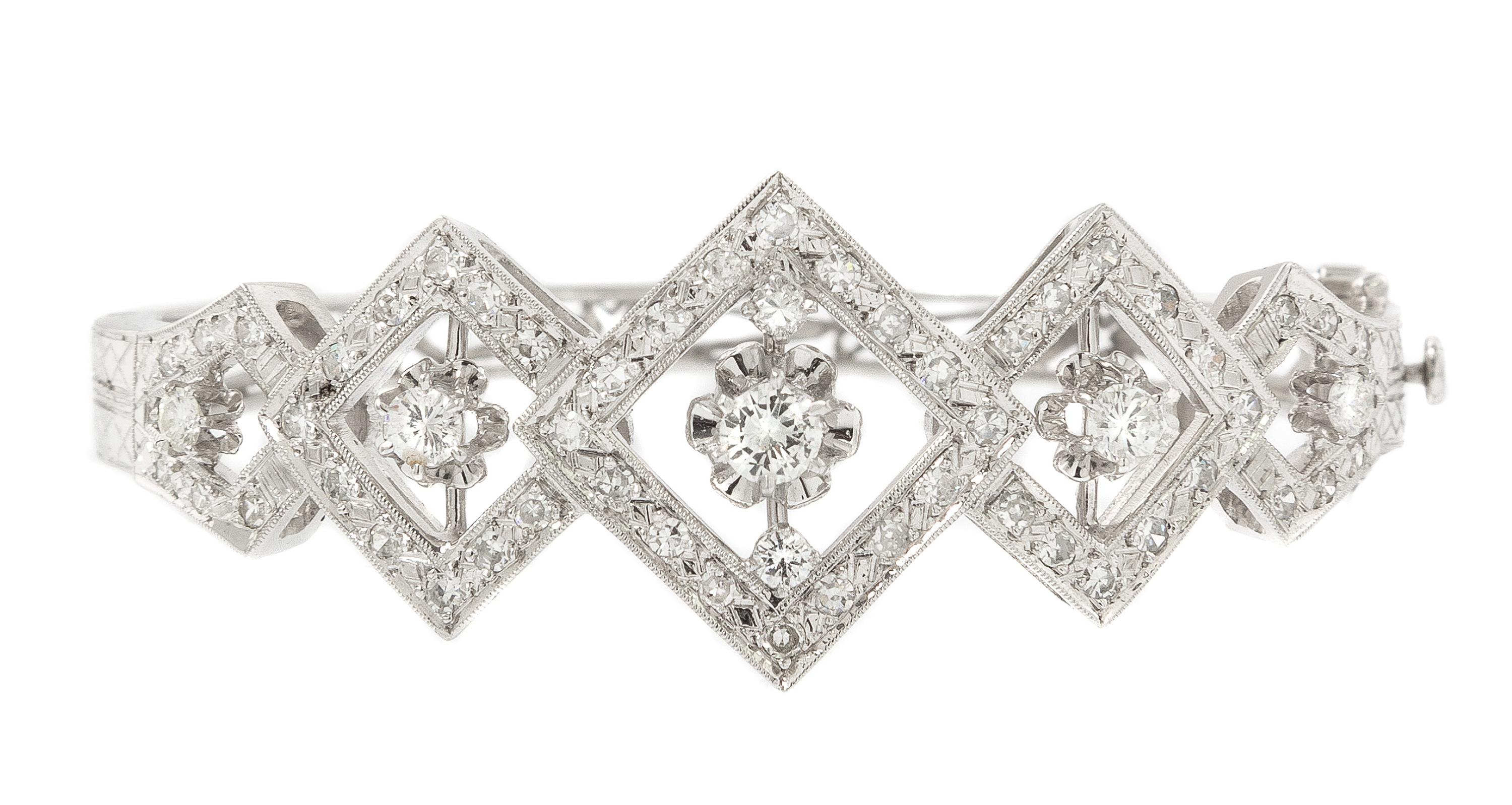 A 14 Karat White Gold and Diamond Hinged Bangle Bracelet, 13.90 dwts.