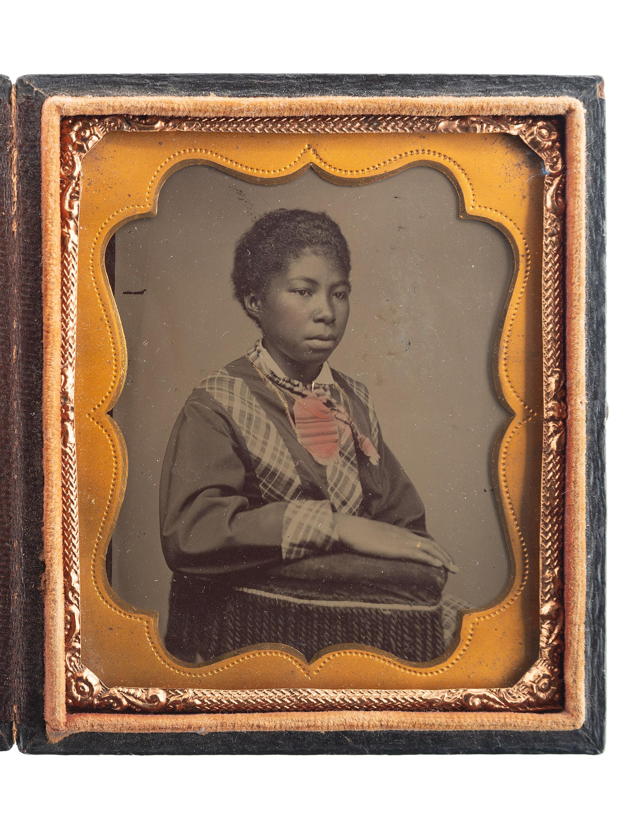 [AFRICAN AMERICANA]. Sixth plate tintype of lovely young African American girl. Ca early 1860s.