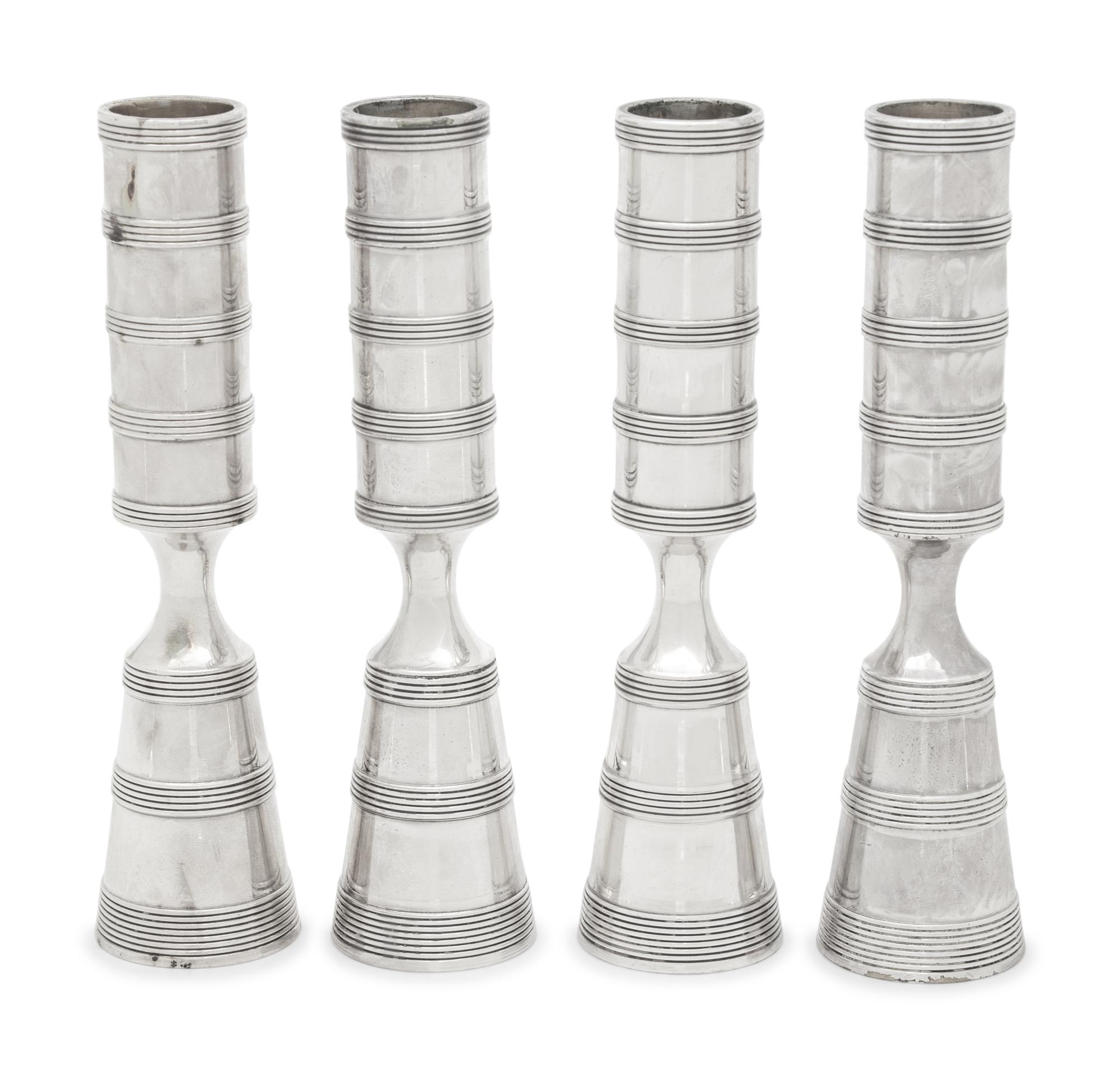 A Set of Four Danish Silvered Metal Candlesticks