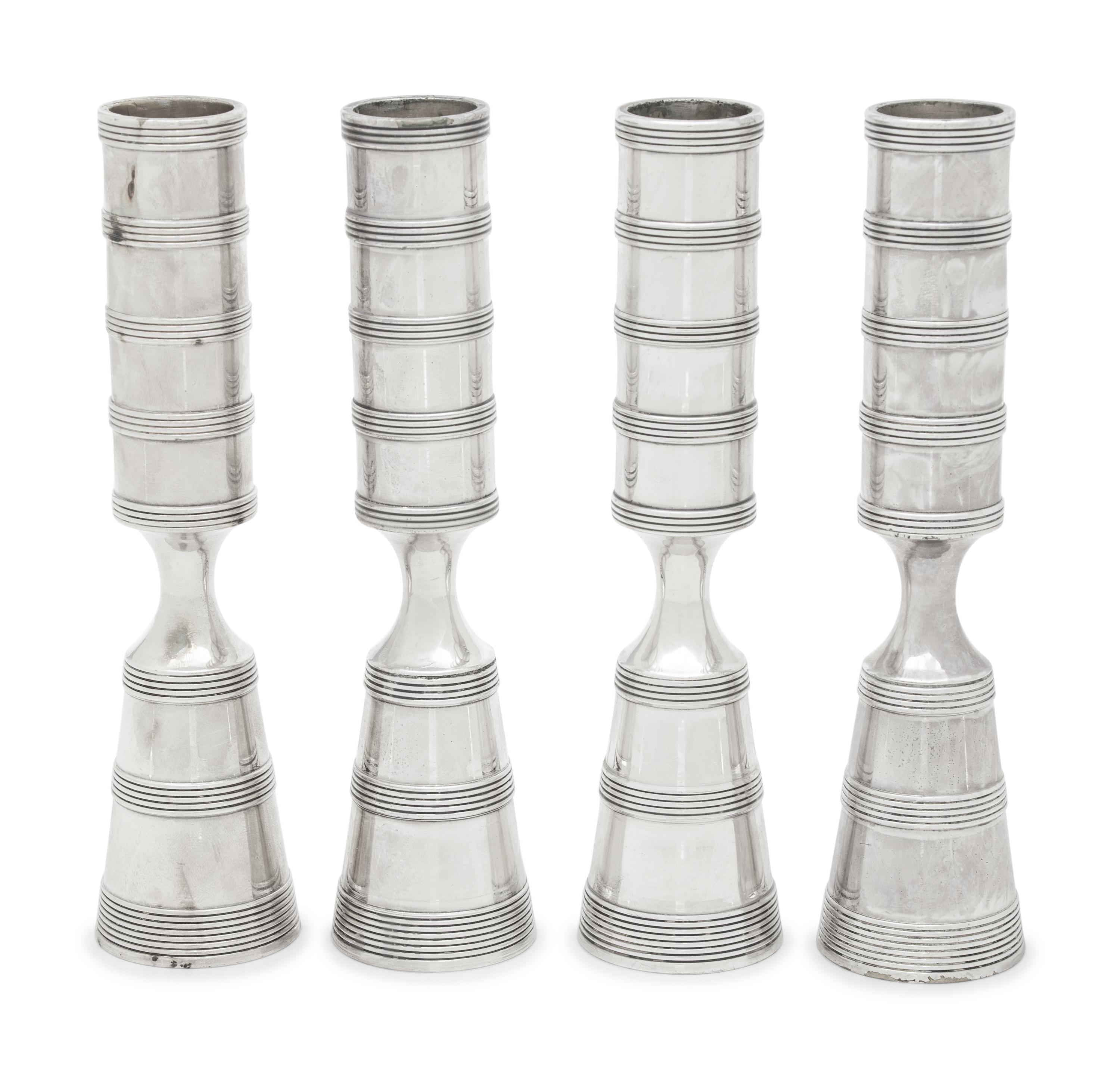 A Set of Four Danish Silvered Metal Candlesticks