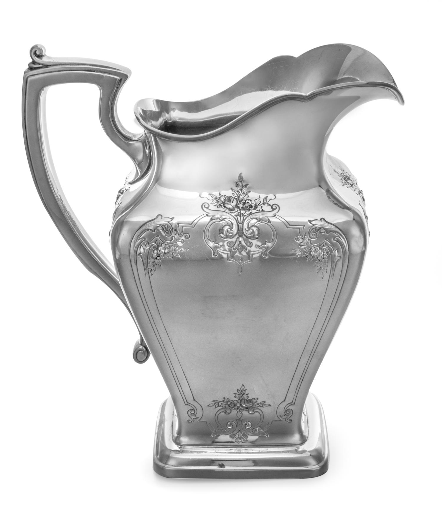 An American Silver Water Pitcher, Reed & Barton, Taunton, MA, the body of square tapering form, worked to show floral sprays and foliat